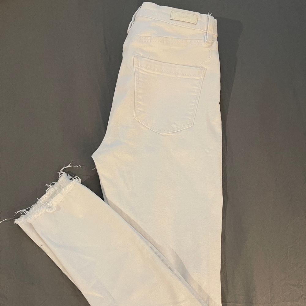 White skinny jeans with stretch and slightly distressed.  Never been worn. 27